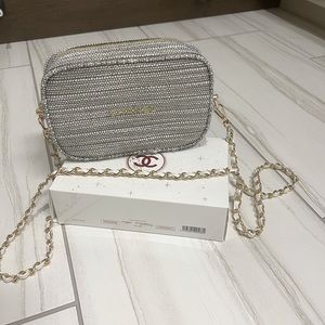 Chanel makeup bag with strap.